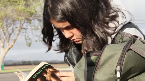 Gender fluid kid reads book Stock Footage 155387997