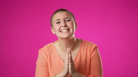 Gender fluid non binary worried pleading woman 20s hold hands folded in prayer Stock Footage 221875526