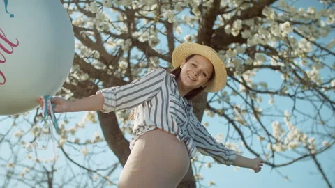 Gender party with a blossoming tree in the background. 4K slow motion Stock Footage 304317116