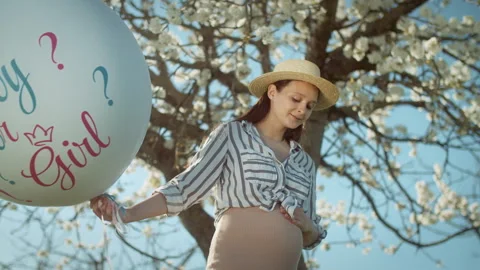 Gender party with a blossoming tree in the background. 4K slow motion Stock Footage 304317514