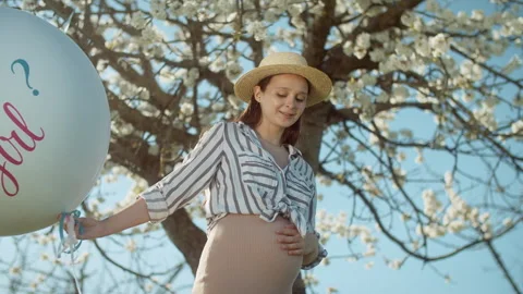 Gender party with a blossoming tree in the background. 4K slow motion Stock Footage 304317533