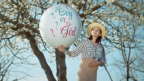 Gender party with a blossoming tree in the background. 4K slow motion Stock Footage 304317818