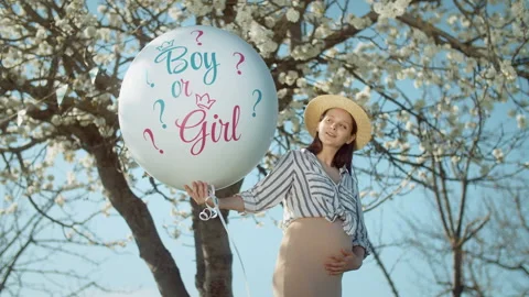 Gender party with a blossoming tree in the background Stock Footage 304317839