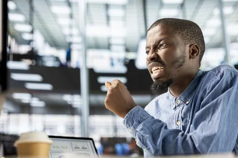 General manager sits at his computer frustrated and overwhelmed Stock Photos
