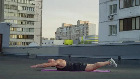 General plan as an athlete lying on his back raises his arms and legs. Stock-Footage 250021547