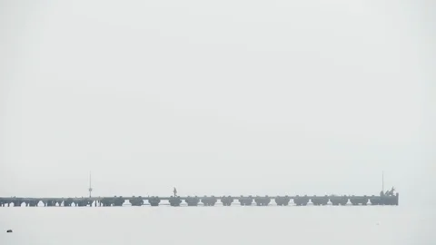General plan berth in fog at the end of sit fishermen Vídeos de archivo 117844891