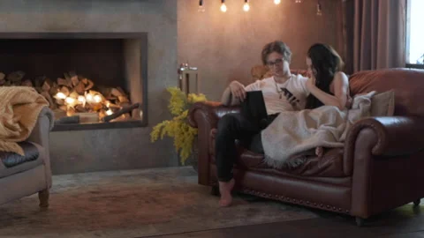 General Plan The Camera Moves Forward A Cute Young Couple A Young Guy Reading Stock Footage 138018788