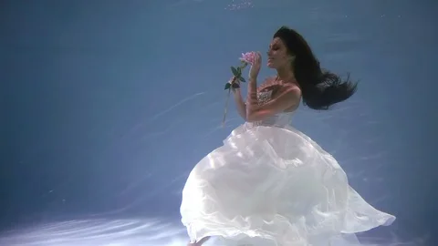 General plan. cute bride in a wedding dress under water like in a fairy tale 스톡 동영상 100138404