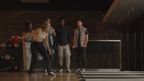 General Plan Female Bowling Player Throws Ball With Support Friends And Rejoices Stock Footage 166493743