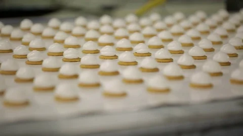 The general plan of round cookies with a white cream on a conveyor Video stock 72953985