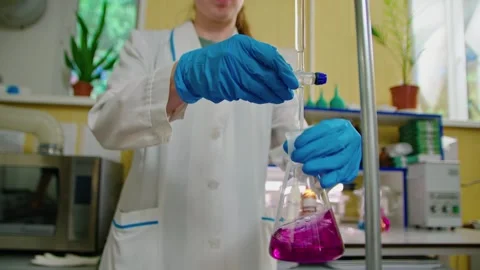 General plan of a scientist in blue gloves conducts research in laboratory Stockbeeldmateriaal 274956040