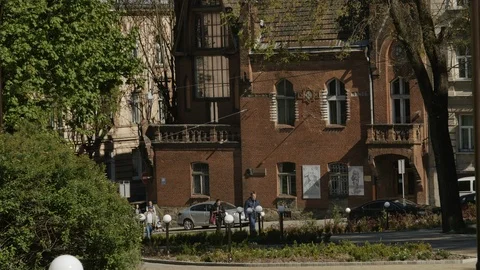 The general plan shot of a building and people are passing by Vidéo 103159817
