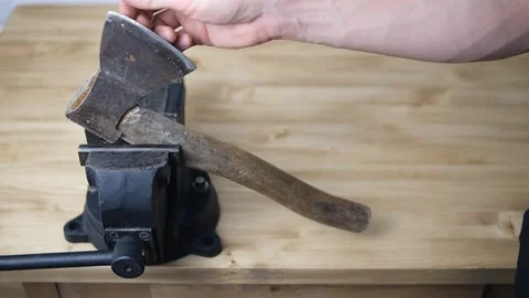 The general plan on a wooden table top is set with a black vise with a screw gri Stock Footage 147905713