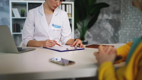General practitioner informing middle-aged woman about bad medical test results Stock Footage 320119850