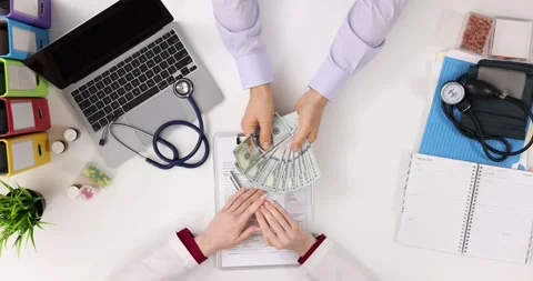 General practitioner shows patient stop sign and refuses to take money at clinic Stock Footage 295253296