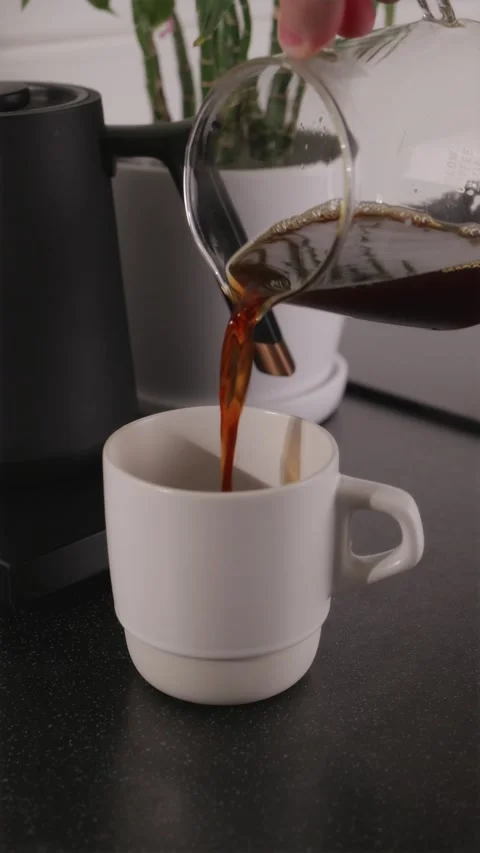 General vertical shot of coffee setup with Spathiphyllum plant Stock Footage 332358807