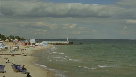 General view of the beach with people on it with green water Stock-Footage 103340879