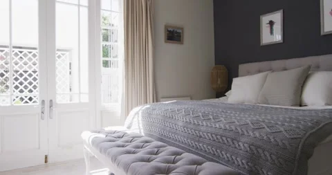 General view of bedroom interior with bed and big window Stock Footage 339320117