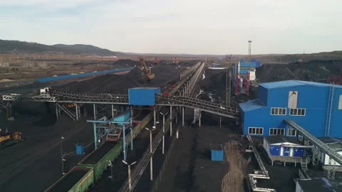General view of the coal mine loading station with moving freight train. Aerial Stock Footage 203918982