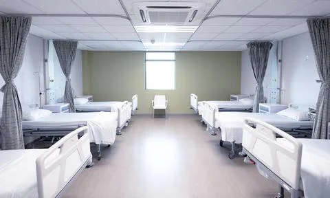 General view of an empty hospital room with two rows of beds Stock Photos