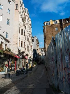 General view of the empty street going up. Construction of a building behind a Stock Photos
