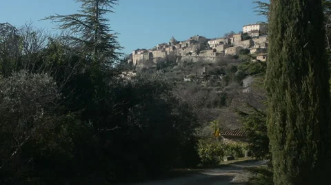 General view of Gordes seen from afar amid trees, Provence, France Stock Footage 66255883