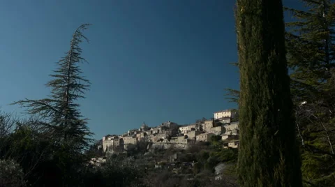 General view of Gordes seen from afar amid trees, Provence, France Stock Footage 66257716