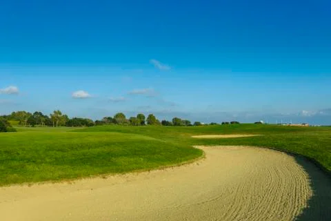 General view of a green golf course on a bright sunny day. Idyllic summer Stock Photos