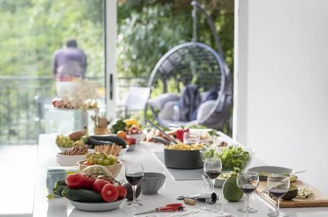 General view of kitchen island with half eaten dishes of food and glasses of Stock Photos