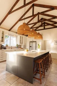 General view of modern kitchen with countertop, chairs and kitchen equipment Stock Photos