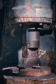 General view of an old rusty percussion machine for forging various metals. Stock Photos