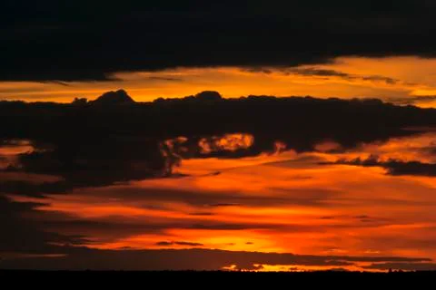 General view of the red sunset with low sun and horizon 写真素材