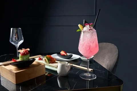 General view of table with a refreshing drink, white plate of sushi pieces Stock Photos