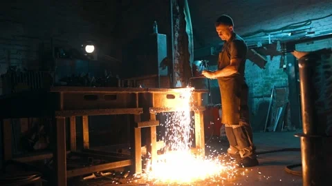 General view of a worker cutting metal with an oxy-fuel torch in a workshop Stock Footage 229613693