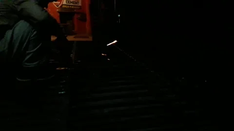 Generating sparks during grinding of iron at welding workshop at night Stock Footage 130867501