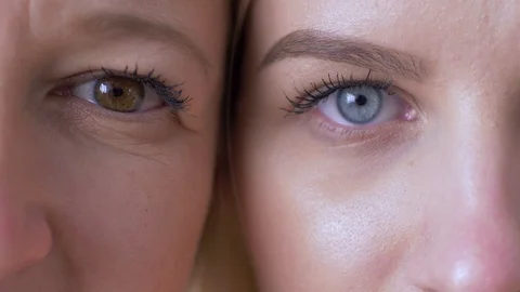 Generation difference, eyes of mum and daughter faces next to one another Vídeos de archivo 103586686