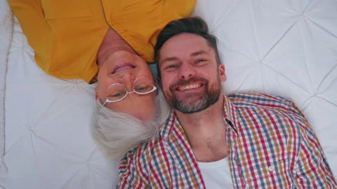 Generational difference between grinning elderly grandma and her content middle Stock Footage 170465031
