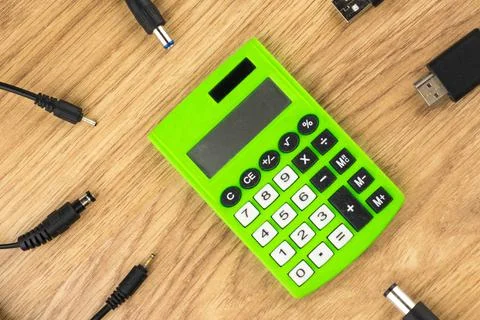 Generations of technology gap: old dusty calculator and lots of plugs and cha Stock Photos