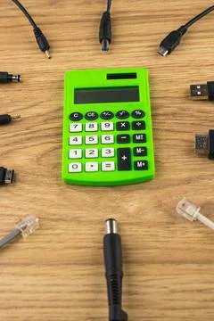 Generations of technology gap: old dusty calculator and lots of different plu Stock Photos