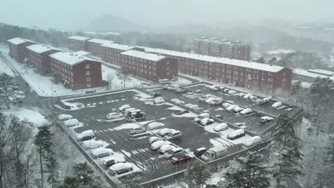 Generic Apartment Block and Parking Lot During Snowfall, Aerial Stock Footage 346397797
