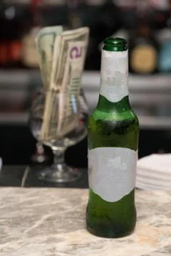 Generic beer bottle with blank label served by bartender waiting for customer Stock Photos
