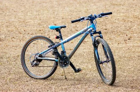 A generic bicycle on stand in a field Stock Photos