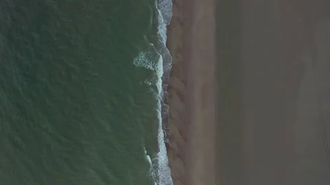 Generic Brown Beach Pattern and Dark Green Ocean on Cloudy Day, Top Down Video stock 139691074