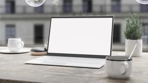 Generic laptop computer and coffee cup resting on wooden table. Blank screen  Foto stock