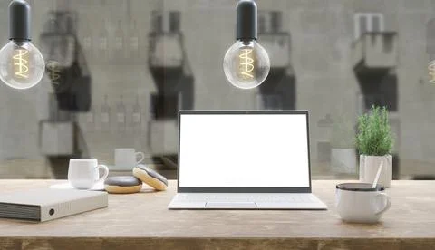Generic laptop computer and coffee cup resting on wooden table. Blank screen  Foto stock