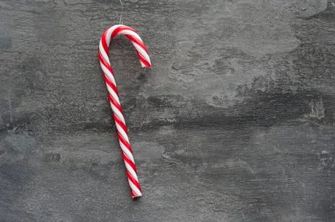Generic machine made christmas candy cane ornament on rustic style background Stock Photos