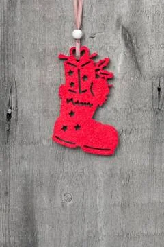 Generic machine made christmas stocking boot ornament on rustic style backgro Stock Photos
