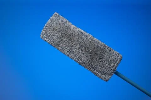 Generic plastic sweeping mop with a dirty textile sponge. Close up studio sho Fotos de archivo