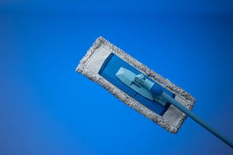 Generic plastic sweeping mop with a dirty textile sponge. Close up studio sho Fotos de archivo