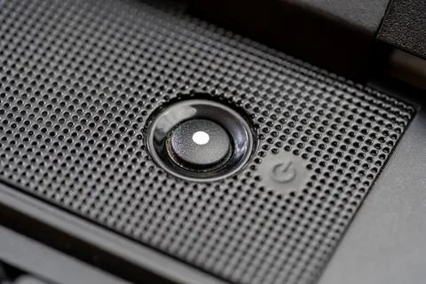 Generic round circle power button light on a modern laptop computer, high a.. Stock Photos